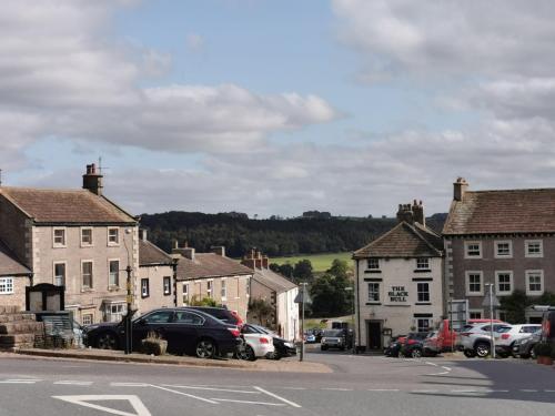 a small town with cars parked on a street at The Black Bull Inn in Middleham