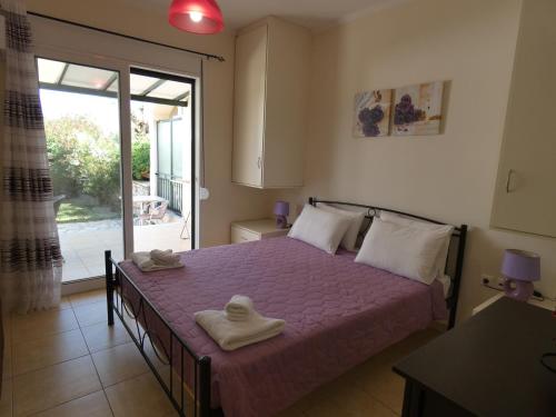 a bedroom with a bed with towels on it at Vivere Apartment Barbati Beach in Barbati