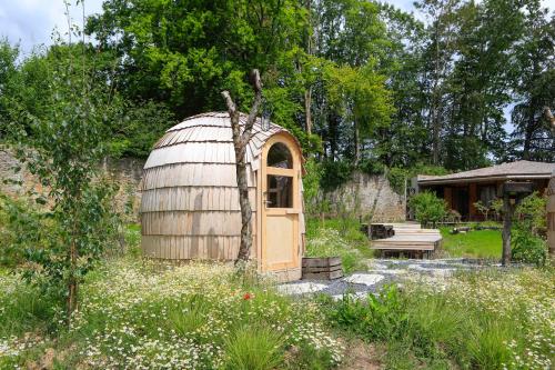 a wooden observatory in a garden with a bench at Domaine de Ronchinne - Château et Ecuries in Maillen