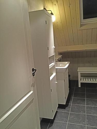 a bathroom with a sink and a white door at Christinahoeve Logies in Boskoop