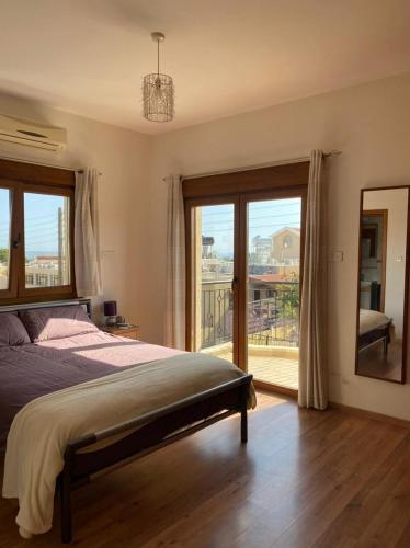 a bedroom with a bed and a view of a balcony at EPISKOPI VILLA, Luxury 4 Bedroom with Pool - Limassol in Limassol