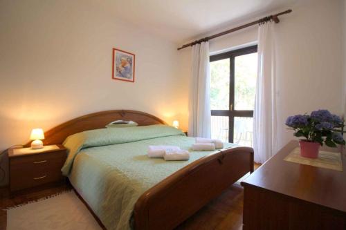 a bedroom with a bed with two towels on it at Apartment in Porec/Istrien 36682 in Poreč