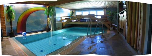 a large swimming pool with a rainbow on the wall at Apartments in Dienten am Hochkönig 225 in Dienten am Hochkönig