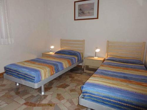 A bed or beds in a room at Apartments in Bibione 24609