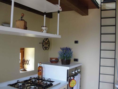 a kitchen with a stove and a white stove top oven at Holiday home in Madonna Del Sasso 22866 in Madonna del Sasso