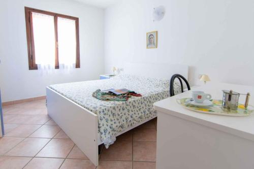 a bedroom with a bed and a table with a plate at Apartments in Capoliveri/Insel Elba 23660 in Capoliveri