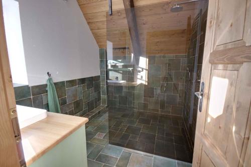 a bathroom with a shower with tiled floors and a sink at Holiday home in Horni Marsov 30398 in Horní Maršov