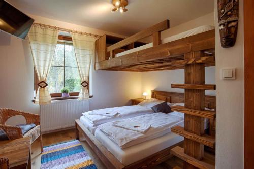 a bedroom with a bunk bed with a ladder at Holiday home in Harrachov 33511 in Harrachov