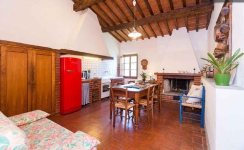 a living room with a red refrigerator and a table at Apartment in Bagno a Ripoli/Toskana 23871 in Villamagna