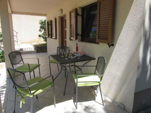 a table and chairs sitting on a patio at Apartments Karlobag/Velebit Riviera 17136 in Vidovac
