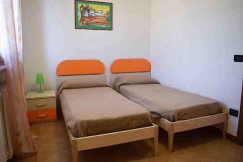 a room with two beds in a room with a table at Holiday home in Bardolino/Gardasee 21875 in Bardolino