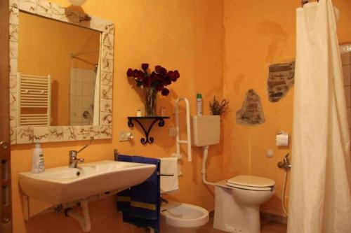 a bathroom with a sink and a toilet and a mirror at Holiday home in Urbino - Marken 35804 in Urbino