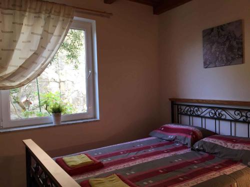a bedroom with a bed and a window at Apartments in Klimno/Insel Krk 12514 in Klimno