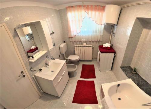 a bathroom with a sink and a toilet and a tub at Apartment in Krsan 8830 in Kršan