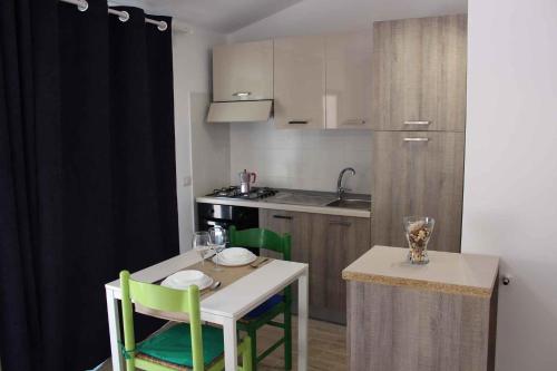 a kitchen with a table and chairs and a kitchen with a sink at Studio in Siracusa/Insel Sizilien 34738 in Siracusa