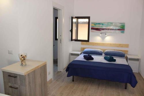 a bedroom with a bed with blue sheets and pillows at Studio in Siracusa/Insel Sizilien 34738 in Siracusa