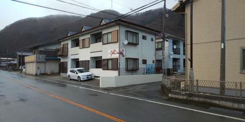 a white car parked in front of a building at Akira Peak House Kinugawa in Kinugawaonsen Ohara