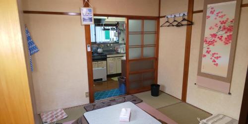 a room with a kitchen with a table in it at Akira Peak House Kinugawa in Kinugawaonsen Ohara
