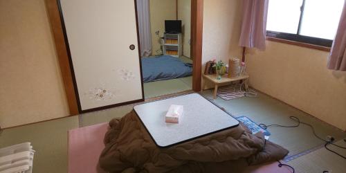 a living room with a table and a mirror at Akira Peak House Kinugawa in Kinugawaonsen Ohara