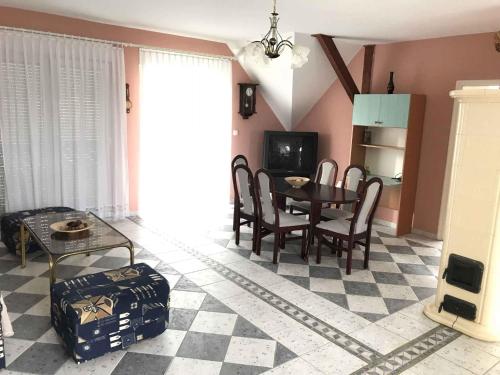 un soggiorno con tavolo, sedie e divano di Holiday home in Balatonboglar 35154 a Balatonboglár