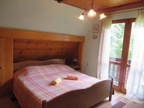a bedroom with a bed with a checkered blanket at Holiday home in Turke/Gorski Kotar 34884 in Turke
