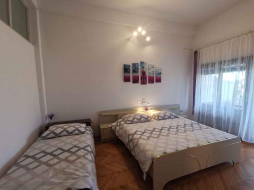 a bedroom with two beds and a window at Apartment in Crikvenica 27813 in Dramalj