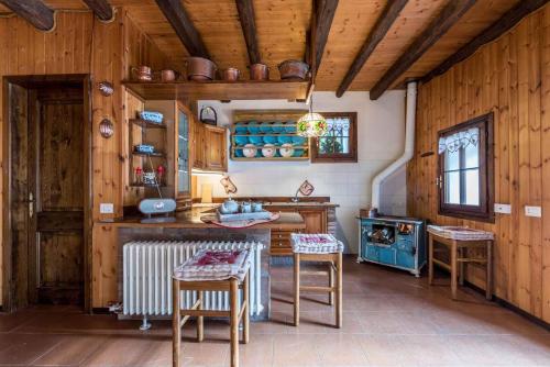 een keuken met houten wanden en houten tafels en stoelen bij Holiday home in Molina in Lenzumo di Concei