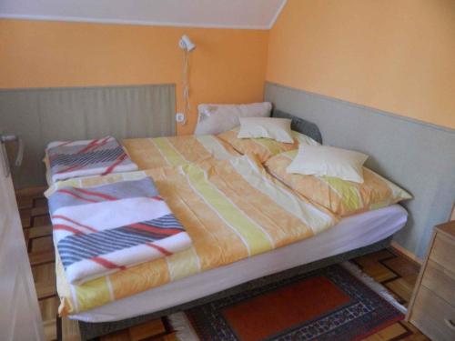 a bed with a colorful blanket on top of it at Apartments in Cserkeszolo/Ostungarn 34460 in Cserkeszőlő