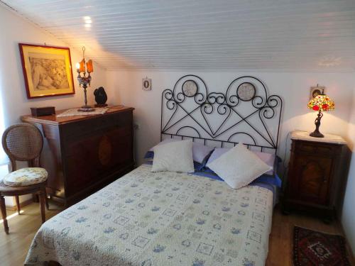 a bedroom with a bed and a dresser and a table at Apartment Volosko 15685 in Volosko
