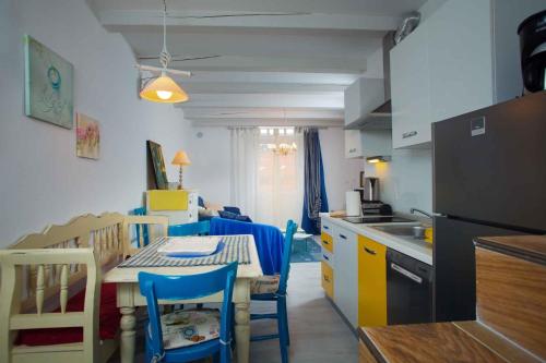 a kitchen and dining room with a table and chairs at Apartment in Rovinj/Istrien 11735 in Rovinj