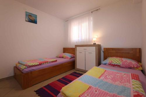 a bedroom with two beds and a window at Apartment in Silo/Insel Krk 13587 in Šilo