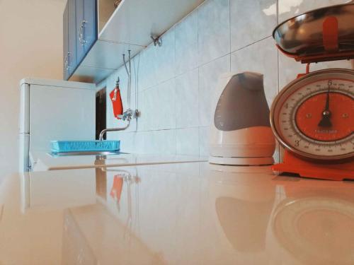 a kitchen with a sink and a clock on a counter at Apartment in Maslenica 6886 in Maslenica