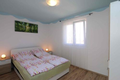 a small bedroom with a bed and a window at Apartment in Silo/Insel Krk 13586 in Šilo