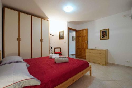 a bedroom with a large bed and a dresser at Two-Bedroom Apartment in Siracusa II in Ognina