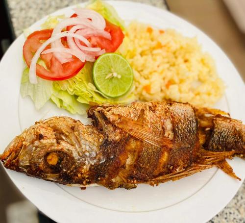 a plate of food with fish rice and vegetables at Hotel en Guadalajara Posada Mi Rey in Guadalajara