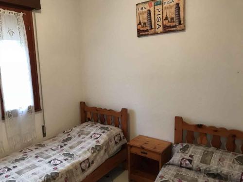 a bedroom with two twin beds and a window at Apartment in Rosolina Mare 25092 in Rosolina Mare