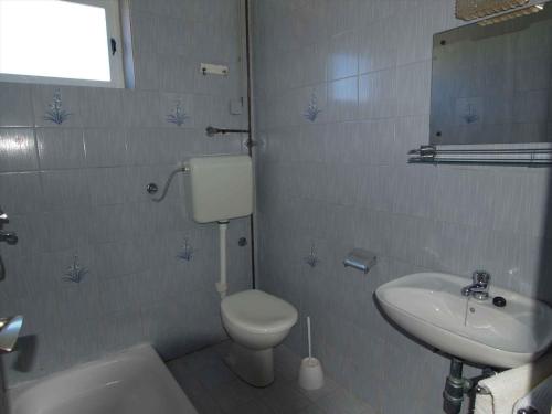 a bathroom with a toilet and a sink at Apartment in Rab/Insel Rab 16489 in Palit