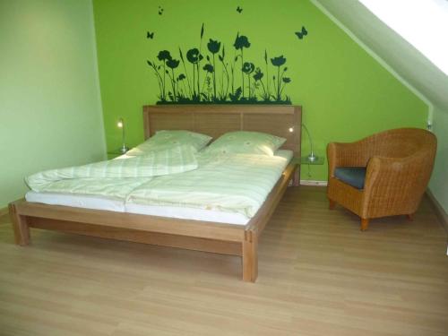 a bedroom with a bed with a plant on the wall at Apartment in Trebbin 2612 in Blankensee
