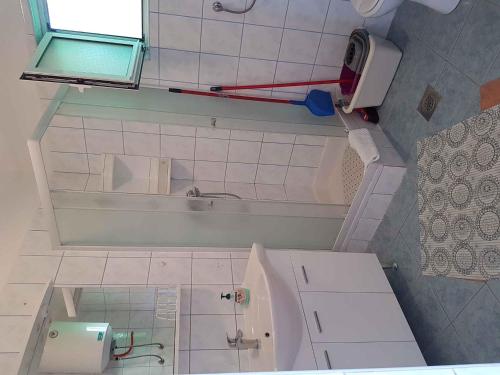 a small bathroom with a tub and a sink at Apartment in Lopar with Two-Bedrooms 3 in Lopar