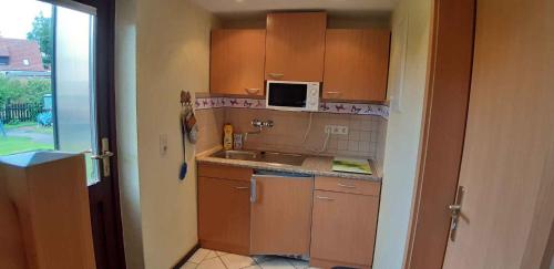 a small kitchen with a sink and a microwave at Holiday Home Uckeritz - Seebad 1 in Ueckeritz