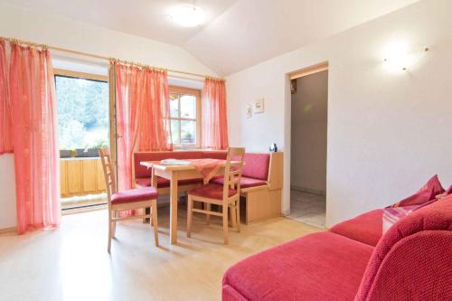 a living room with a table and a couch at Apartment in Schlitters with Two-Bedrooms 1 in Schlitters