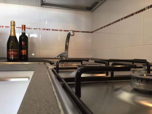 a kitchen with two bottles of wine on a stove at Two-Bedroom Apartment in Rosolina Mare - Venetien 25064 in Rosolina Mare