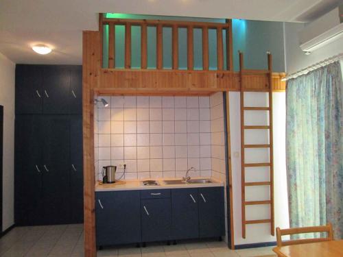 a loft bed in a kitchen with a sink and a counter at Vodice Apartment 2 in Vodice