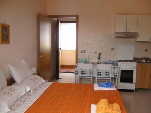 a room with a kitchen with a bed in it at Studio in Letojanni/Sizilien 23302 in Letojanni