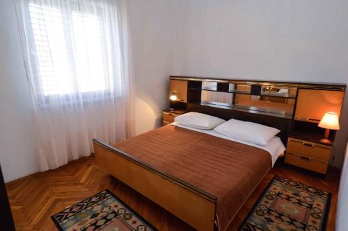 a bedroom with a large bed and a window at Apartments in Premantura/Istrien 10684 in Premantura