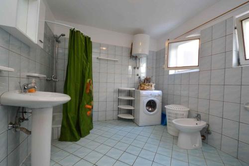 a bathroom with a sink and a washing machine at Apartment in Pula/Istrien 10862 in Veruda