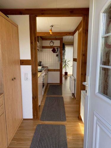 a hallway leading to a kitchen with wooden floors at Holiday home in Gustow/Insel Rügen 3077 in Gustow