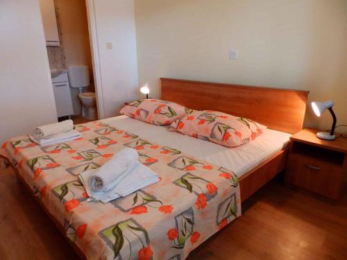 a bedroom with a bed with two towels on it at Kampor Apartment 9 in Supetarska Draga