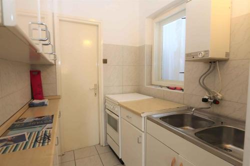 a small kitchen with a sink and a window at Silo Apartment 17 in Šilo