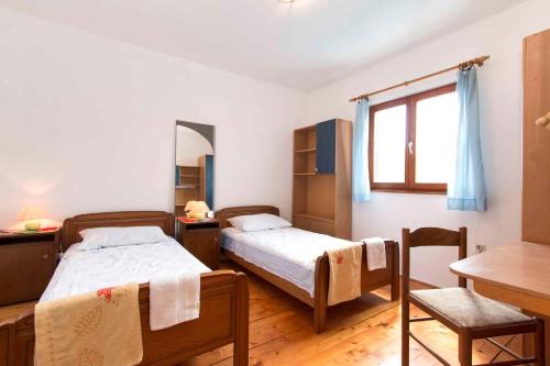 sypialnia z 2 łóżkami, stołem i oknem w obiekcie Holiday home in Fazana/Istrien 11339 w mieście Fondole